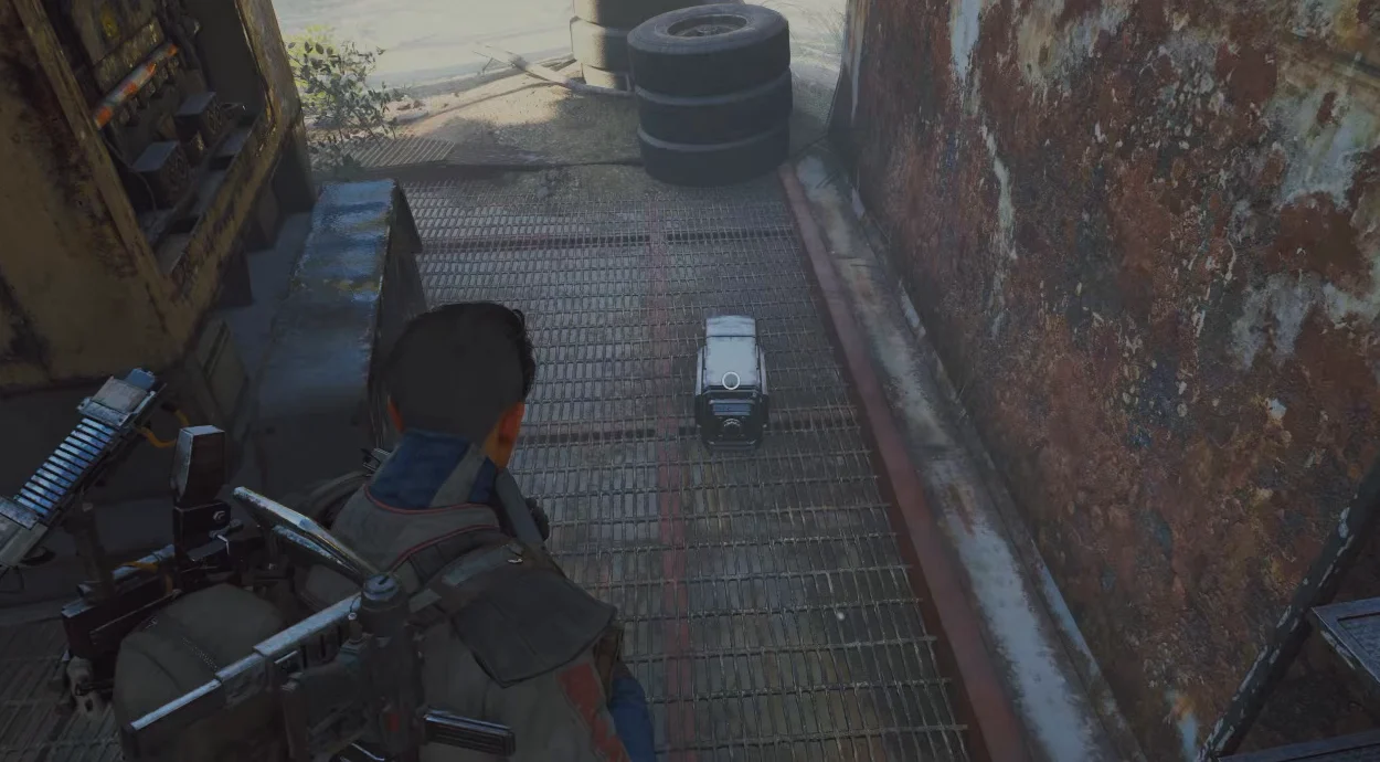 ARC Raiders Dam Battlegrounds Field Crate on a metal walkway beside a yellow machine before the player picks it up